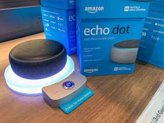 Amazon Echo Dots on a store shelf.