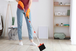 a woman using a broom
