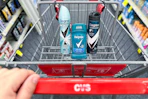 person pushing a cart with degree deodorant in it