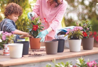 mother and child planting in the Vigoro planters