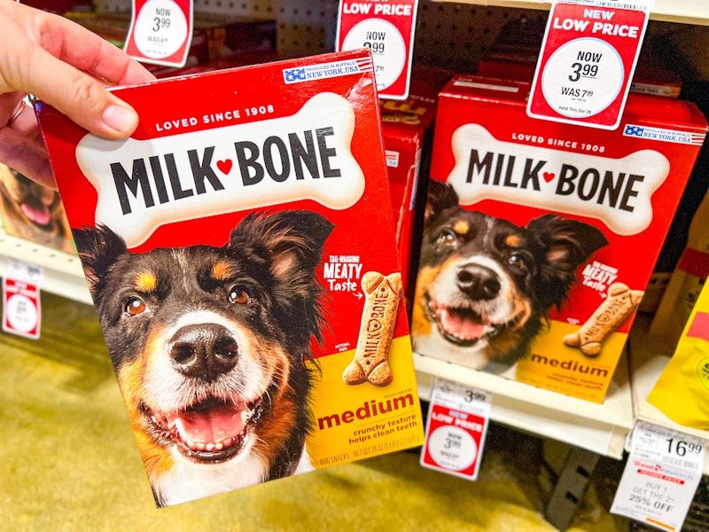 person grabbing a box of milk bone dog treats