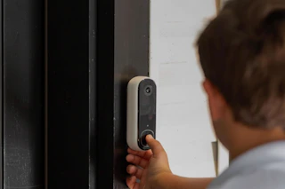 someone ringing an Arlo doorbell