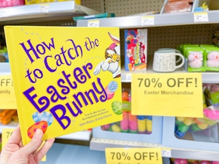hand holding book next to easter clearance at wlgreens