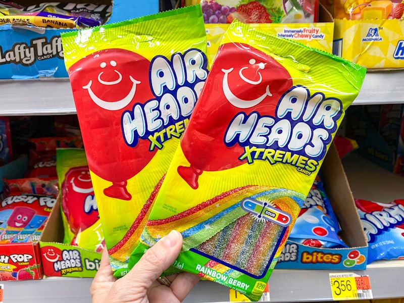 hand holding two airheads xtremes candy at walmart