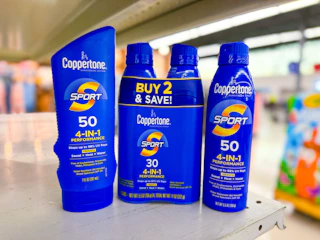 hand holding coppertone sunscreens