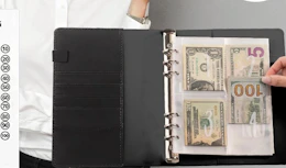 a money saving challenge binder with money inside 