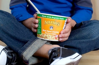 child holding annies mac and cheese product
