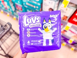 hand holding luvs diapers in walgreens