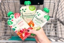 hand holding beech-nut baby food pouches over shopping cart