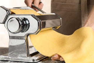 Person using a pasta maker