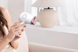 a person holding an IPL Laser Hair Removal Device