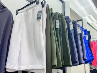 rack of ID Ideology fleece shorts in navy, white and green colors