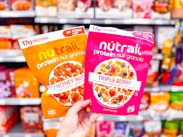 2 Nutrail Cereal held up in grocery aisle at Walmart