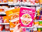 2 Nutrail Cereal held up in grocery aisle at Walmart