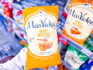 hand holding a bag of Miss Vickie's chips