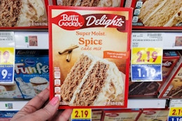 hand holding a box of betty crocker cake mix at kroger