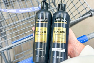 hand holding two bottles of Tresemme shampoo and conditioner