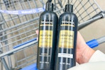 hand holding two bottles of Tresemme shampoo and conditioner