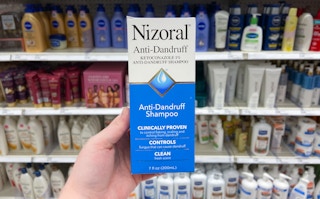 hand holding nizoral anti-dandruff shampoo