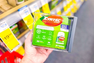 person holding a package of zyrtec allergy relief tablets