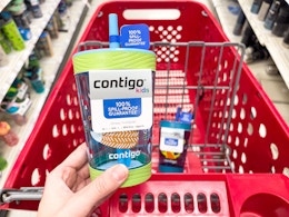 A hand holding a childrens contigo tumbler