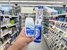hand holding crest and oral-b products