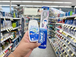 hand holding crest and oral-b products