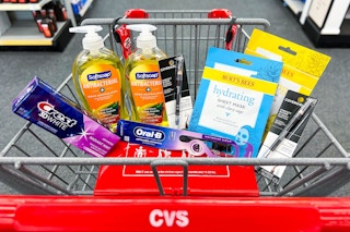 cvs shopping cart with softsoap, crest, burt's bees, and covergirl products