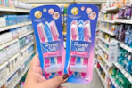 hand hodling two packs of schick touch up razors
