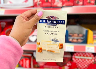 hand holding bag of Ghirardelli chocolate squares