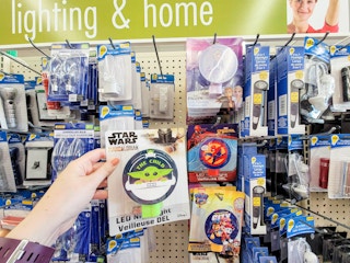 hand holding a mandalorian night light by frozen, spider man, and paw patrol night lights