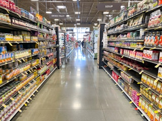 A fully stocked grocery store aisle.