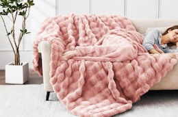 a pink fluffy blanket on a couch 