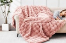 a pink fluffy blanket on a couch