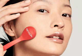 a person using a microdermabrasion wand on their face