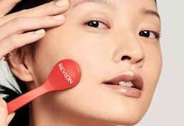 a person using a microdermabrasion wand on their face