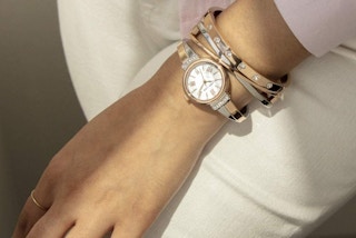 A woman wearing an Anne Klein rose gold watch and bracelet set
