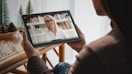 a person holding an Android table watching a video 