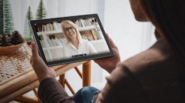 a person holding an Android table watching a video 