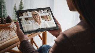 a person holding an Android table watching a video