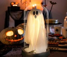a ghost decoration on a table with Halloween decor