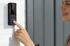 a person ringing a video doorbell