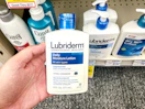 hand holding lubriderm lotion in cvs