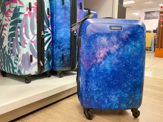 luggage on the floor next to a shelf of other luggages