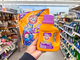 hand holding arm & hammer laundry items in walgreens