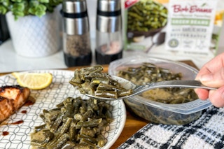 someone taking a spoonful of bob evans green beans