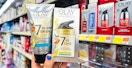 hand holding olay total effects 7-in-one moisturizer with sunscreen spf 15 and revitalizing foaming cleanser in walmart