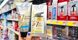 hand holding olay total effects 7-in-one moisturizer with sunscreen spf 15 and revitalizing foaming cleanser in walmart