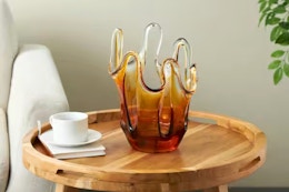 Lifestyle image of a abstract glass vase on wooden table