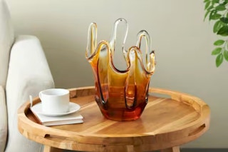 Lifestyle image of a abstract glass vase on wooden table